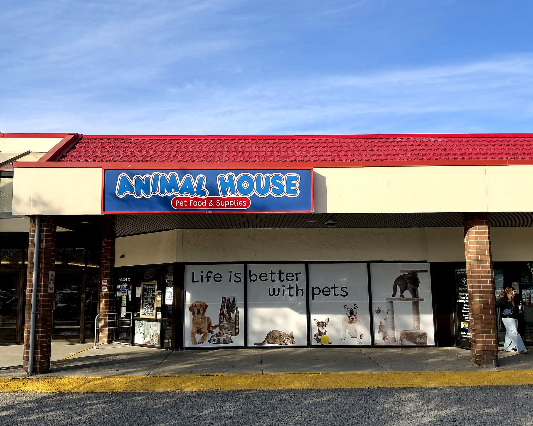 The Animal House storefront at Northills under a blue sky, its windows reading Life is better with pets